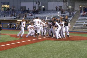 Giants catcher Richard Ortiz is mobbed by his teammates after hitting a walk-off homerun to beat the Edmonton Prospects 5-4. July 24, 2017/Dan Lines