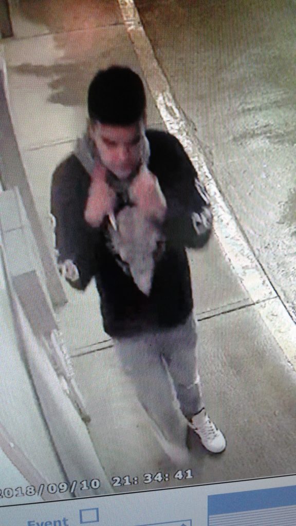 PHOTO. Supplied. Surveillance camera footage produced a photo of a suspect who allegedly assaulted an employee of a local business. The male suspect was wearing blue jeans, white, shoes, grey bandana, a black hoodie with a “Crooks & Castles” logo on the chest and carrying a green and blue knife. He is described as 5’6”. 